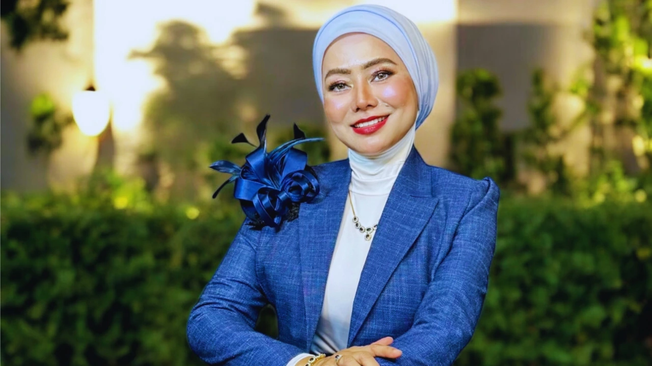 Madam Era in blue jacket and white hijab